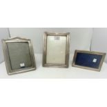 Three hallmarked silver rectangular photo frames: Birmingham 1915, 23 x 17 cm; Chester 1991, 19 x 14