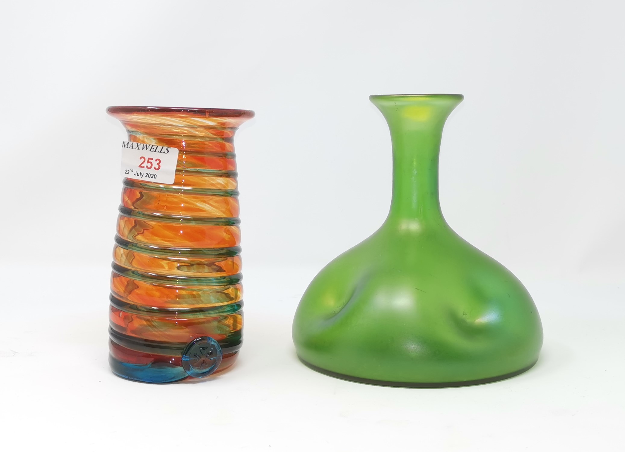 A Mdina orange vase with flared rim; a Loetz style green lustre vase with impressed indentations