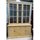 A Victorian full height bookcase/display cabinet with upper glazed doors and 2 pairs of panelled