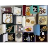 A large selection of costume jewellery brooches, mostly in original boxes