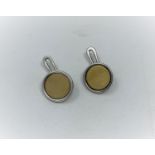 A Georg Jensen pair of sterling silver cufflinks, circular with yellow metal disc, name impressed in