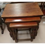 A nest of 3 oak occasional tables; a magazine rack