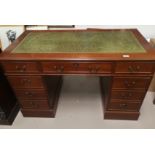 A reproduction mahogany desk on twin pedestals, green leather effect top, 9 pedestal drawers