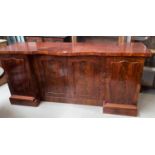 A Victorian mahogany sideboard with shaped front and 4 figured panel doors, length 178 cm