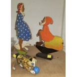 A tinplate windup cat by MAR; 2 painted wooden figures on stand