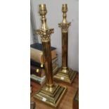 A pair of brass table lamps with Corinthian columns