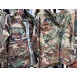 A camouflage jacket; a military jacket with army patches and another