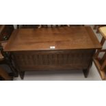 A reproduction carved oak blanket box