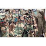 Two US Army camouflage jackets with military patches and another dress Army jacket