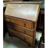 A 1920's walnut fall front bureau of 3 drawers