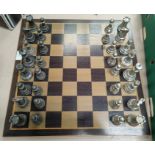 A chess set in pewter and silvered metal with board