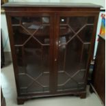 A Georgian style mahogany display cabinet enclosed by 2 astragal glazed doors