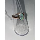 A 9 carat hallmarked rose gold ring, set oval opal