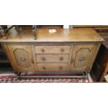 A 1930's oak sideboard of 2 cupboards and 3 drawers on barley twist legs