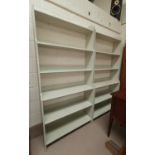 A pair of full height book cases in cream