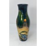 A modern Moorcroft vase of elongated baluster form, decorated with trees in a landscape by Emma