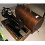 A Singer hand operated sewing machine in oak case