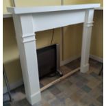 A painted wooden fireplace surround