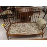 An Ercol style 2 seater settee with floral upholstery