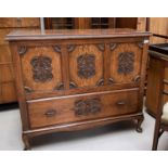 A carved oak mule chest with hinged lid, decorated front panel, single drawer