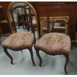 A set of 4 French Provincial salon chairs with carved decoration and cabriole legs upholstered in