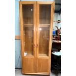 An Ercol Windsor style full height display cabinet