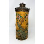 An oriental cylindrical flask decorated in the majolica palette, metal rim, lid and handle, height