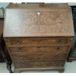 A reproduction fall front bureau in crossbanded burr walnut, with fitted interior and 4 drawers