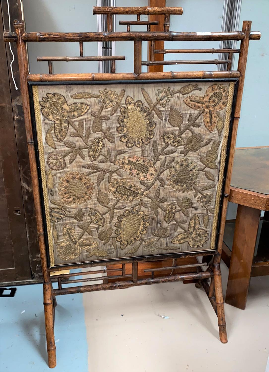 A late 19th/early 20th century bamboo framed screen with silk insert of flowers, height 105 cm