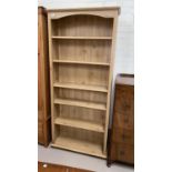 A pine effect full height bookcase
