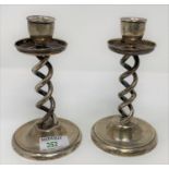 A pair of silver open barley twist candlesticks on circular weighted bases, Birmingham 1924,
