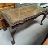 A period style coffee table in carved crossbanded walnut; a similar nest of 3 occasional tables