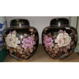 A pair of Chinese cloisonne lidded ginger jars black ground decorated with flowers
