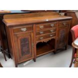 An Edwardian carved mahogany sideboard of 2 cupboards and 5 drawers