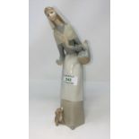 A Lladro figure of a nun; another small figure