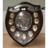 A silvered copper bowling trophy "The Douthwaite Shield" on wooden shield shaped wall plaque