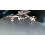 Three gem set dress rings, 3.4 gm; a pearl effect stick pin, boxed