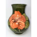 A Moorcroft large baluster vase, hibiscus pattern on a green ground, signed, impressed and with