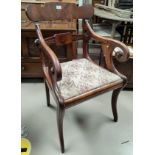 A Regency figured mahogany carver chair with scroll arms, on sabre legs