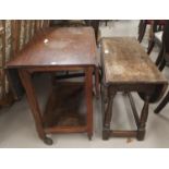 A small oak coffee table with oval drop leaf top; an oak 2 tier tea trolley with drop leaf