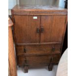 A 1930's oak tallboy with double cupboard and 2 drawers