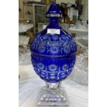 A large covered vase in overlaid Bristol blue with clear stem, on stepped foot, height 36 cm