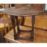 A reproduction oak occasional table with oval drop leaf top; an armchair with rush seat and ladder