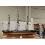 A wooden model of a rigged 3 mast schooner