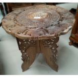 A Far Eastern occasional table with circular carved inlaid top