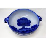 A circular 2-handled fruit bowl by Moorcroft "Dawn" decorated with blue trees in a landscape,