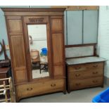 An Edwardian 2 piece bedroom suite in satin walnut comprising mirror door wardrobe and chest of 2