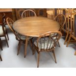 An Ercol drop leaf dining table and 4 hoop back chairs