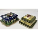 A Victorian majolica butter dish with bird finial and another with fish finial