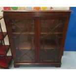 A mahogany reproduction display cabinet with astragal glazed doors